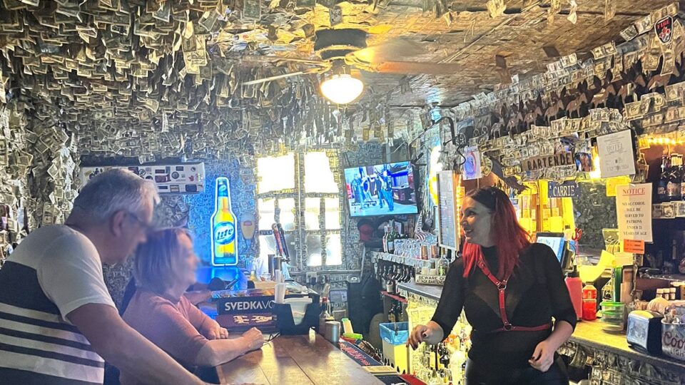 Oatman Hotel Bar - Bartender serving happy customers with dollar bills all around