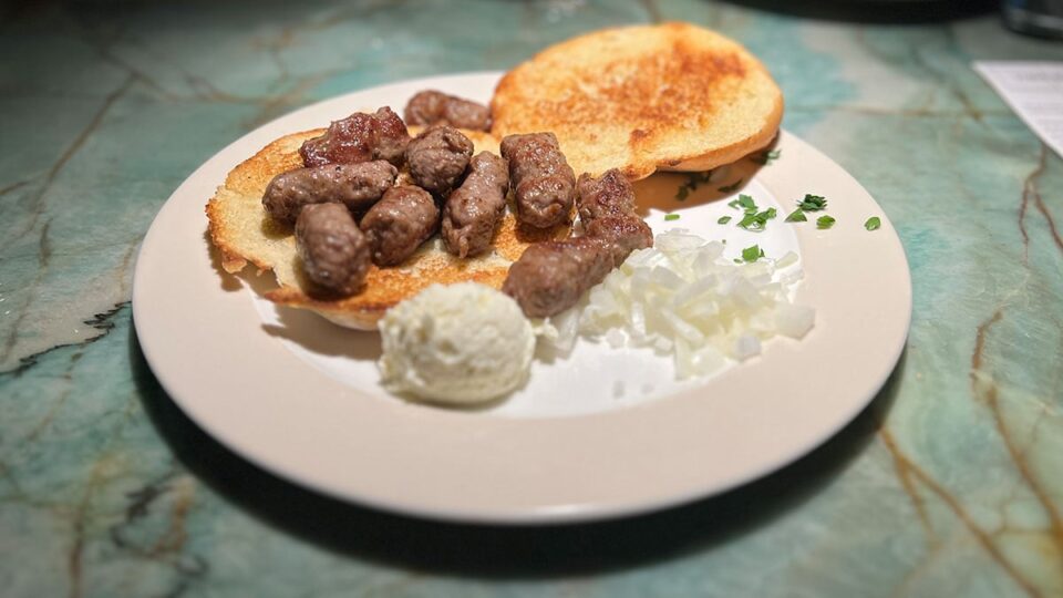 Cevapi sausages served with bread and onions at Beso Restaurant