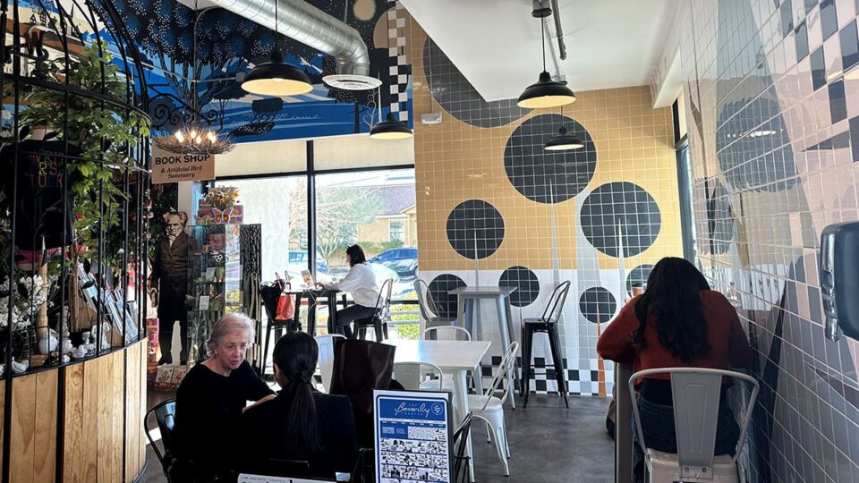 Customers reading and talking over coffee inside The Writer's Block cafe