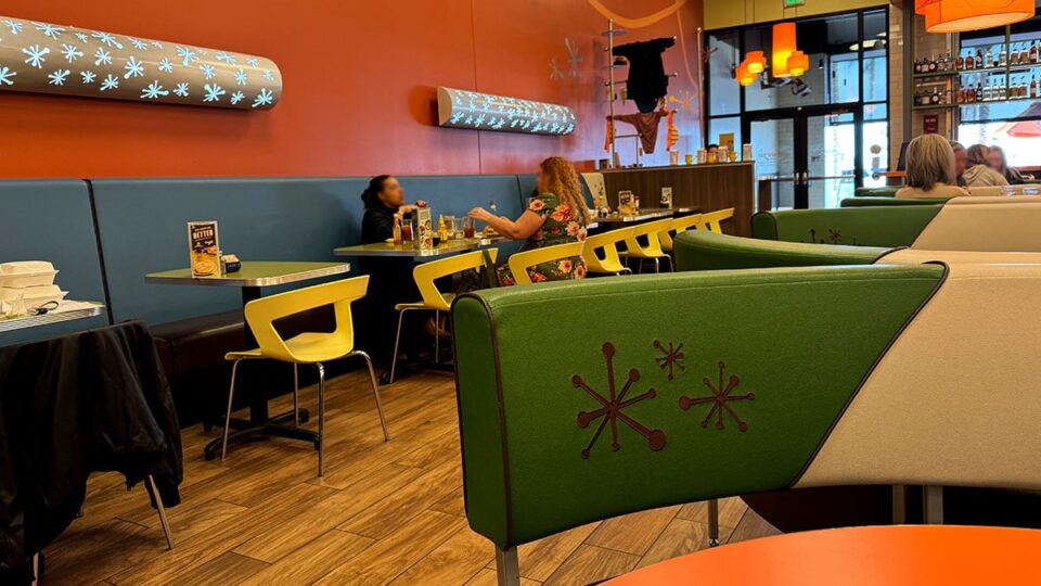 Friends enjoying a conversation over breakfast at Snooze Summerlin