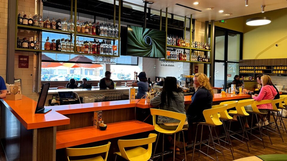 Full Bar Serving mimosas with inside and outside seating at Snooze Eatery