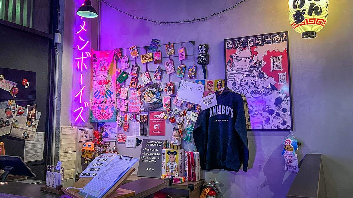 merch wall and signatures at Ramen Boys