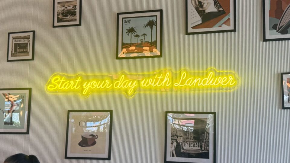 Entrance wall with a neon sign - Start your day with Landwer
