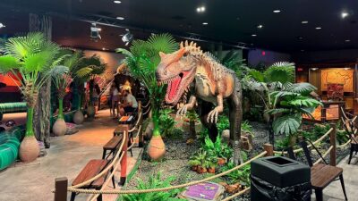 T-Rex standing tall among other dinosaurs at the Dinosaur Outpost