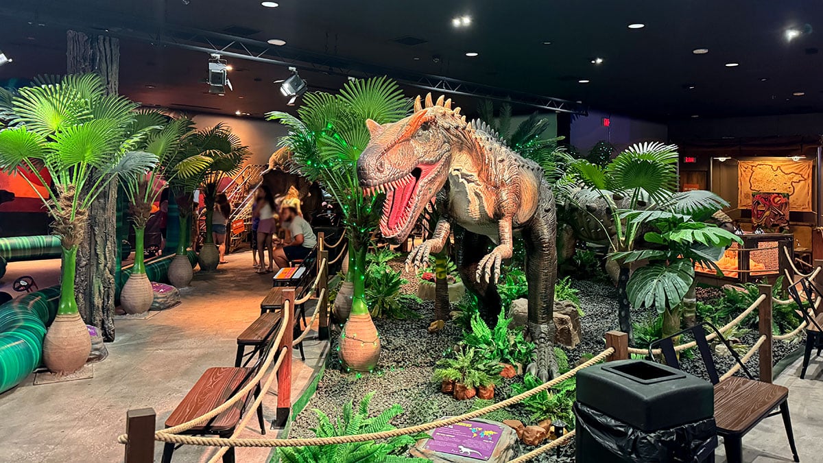 T-Rex standing tall among other dinosaurs at the Dinosaur Outpost