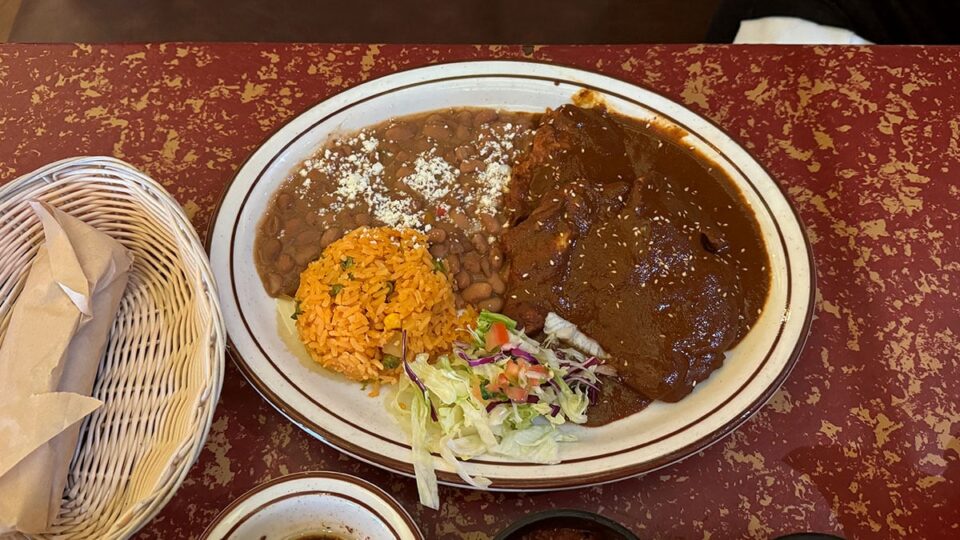 Chicken Mole Poblano with rice, beans, and tortillas
