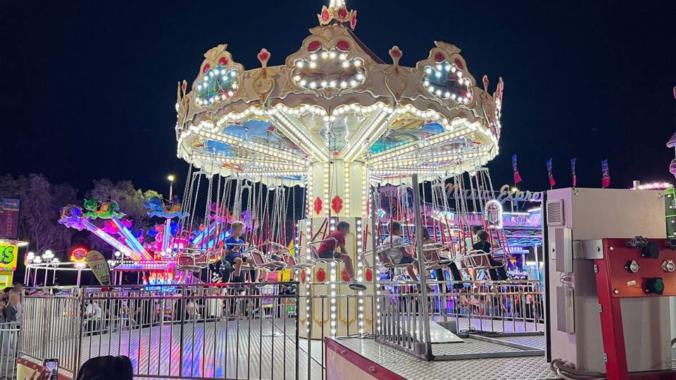 Colorful carnival ride at night.