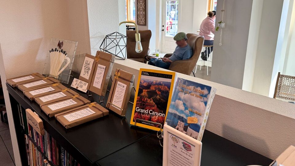 Books and travel guides at Dam Roast House & Browder Bookstore for guests to browse.