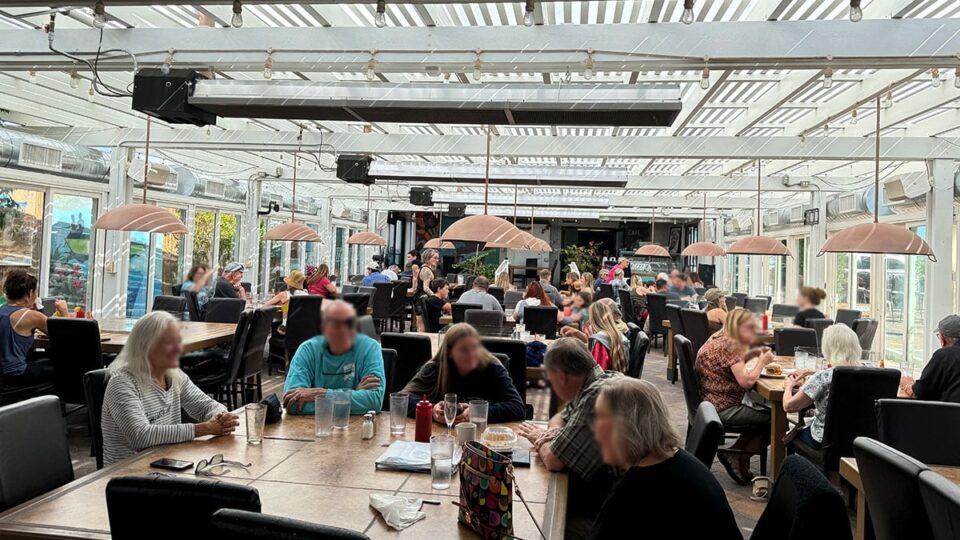 bright greenhouse-style patio filled with natural light at The Patio at Chilly Jilly’z