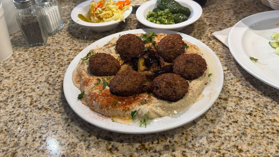 Crispy falafel served over creamy hummus with tahini and grilled eggplant.