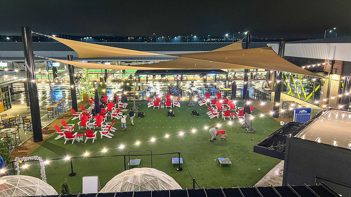 view of Chicken N Pickle courtyard with lights