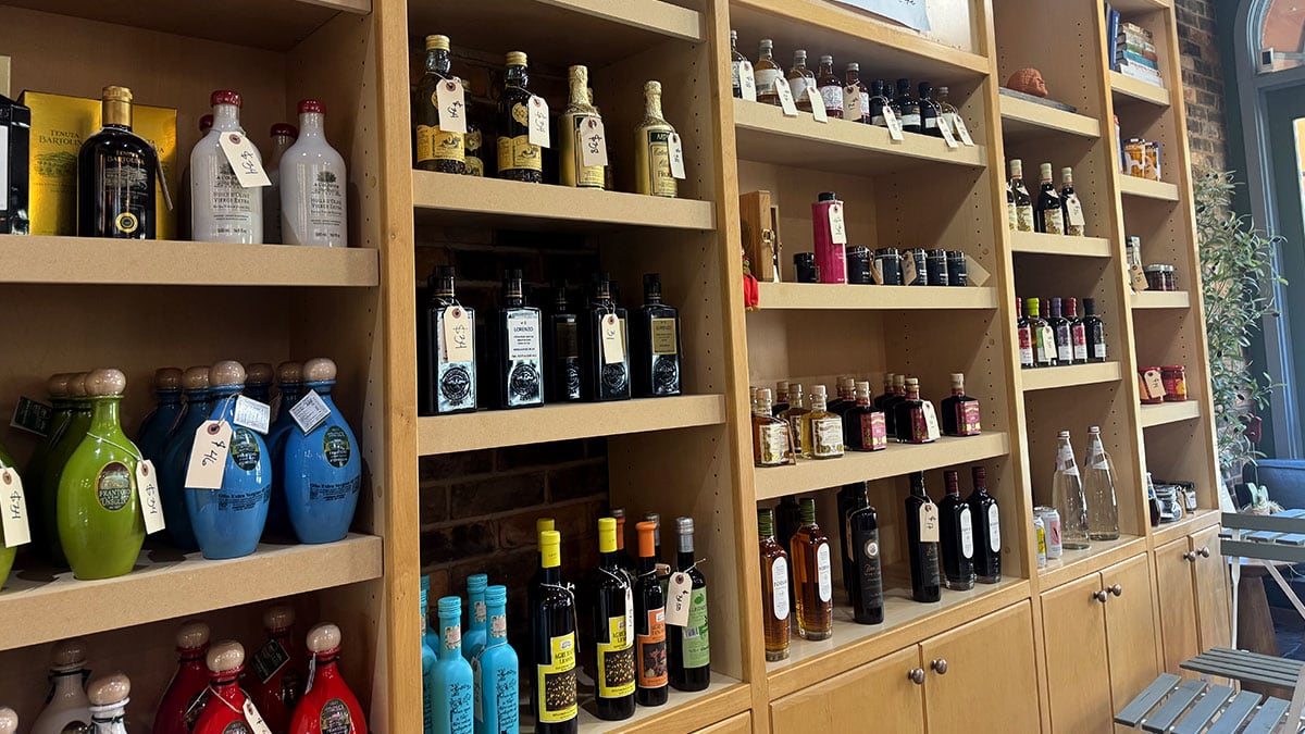 Shelves filled with imported olive oils and vinegars inside A&M Pasta Lab.