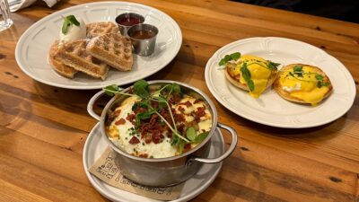 Brunch spread at Honey Salt featuring churro waffles, eggs benedict, and breakfast poutine