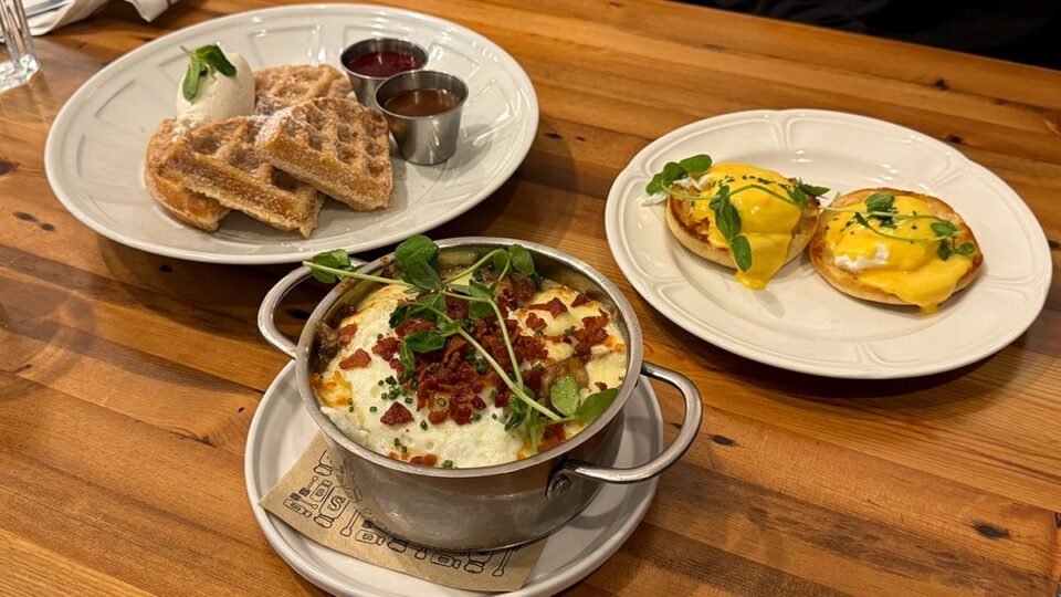 Brunch spread at Honey Salt featuring churro waffles, eggs benedict, and breakfast poutine