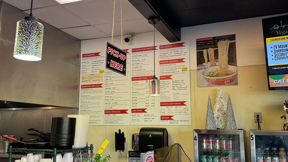 Wall-mounted menu display featuring Buldogis hot dog and bowl options.