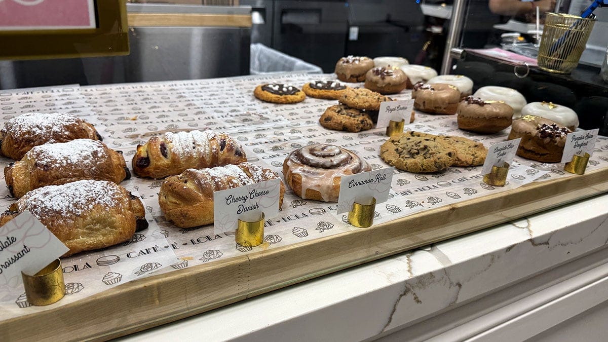 Assorted Cafe Lola pastries displayed with decorative toppings.