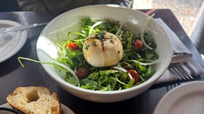 Chèvre chaud salad with baked goat cheese and arugula at Ohlala French Bistro