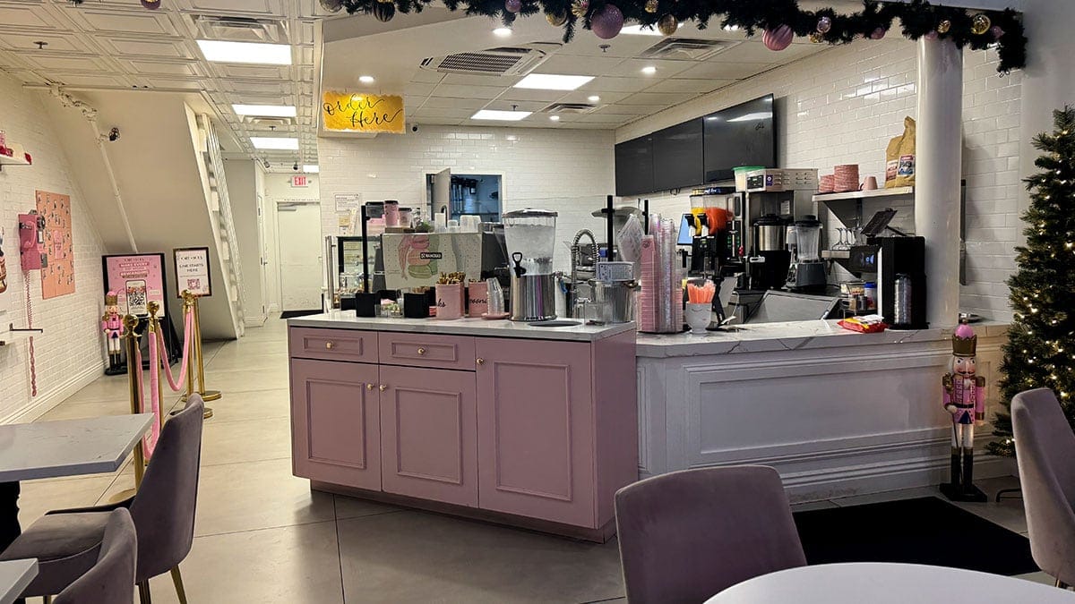 Cafe Lola counter area featuring decorative design elements, a clean layout, and a charming, upscale café setting.