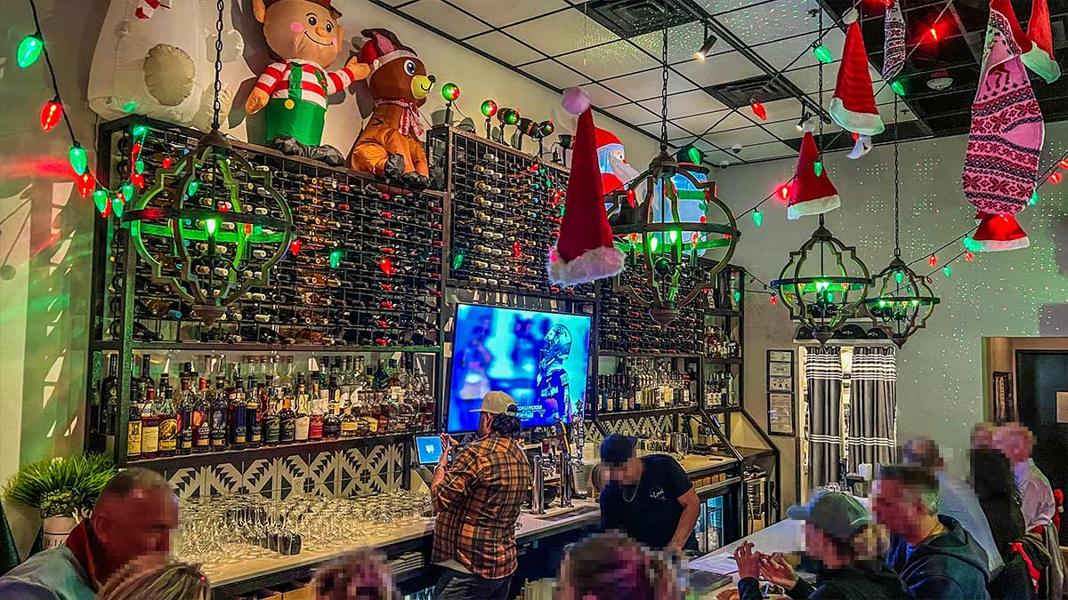 The Local bar with wine bottle wall and holiday décor