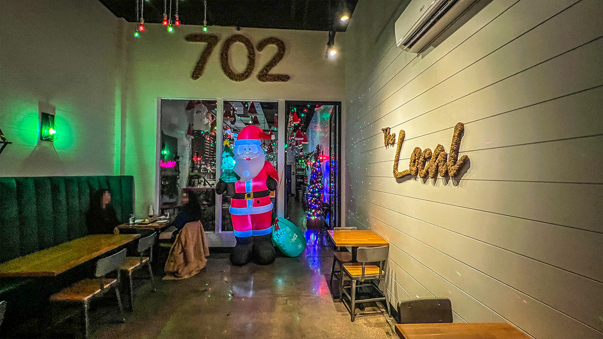 Interior entrance of The Local with holiday décor and seating