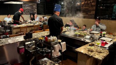 Family enjoying an interactive hibachi dinner at Ohjah Japanese Steakhouse