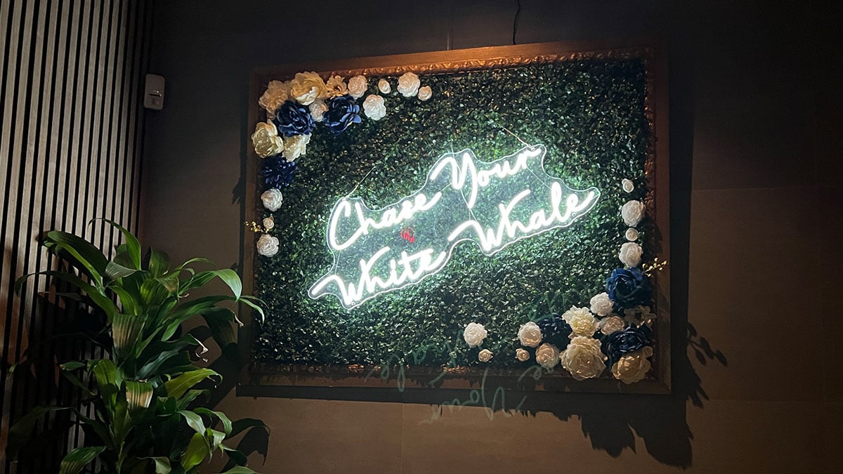 “Chase Your White Whale” signage inside White Whale bar.