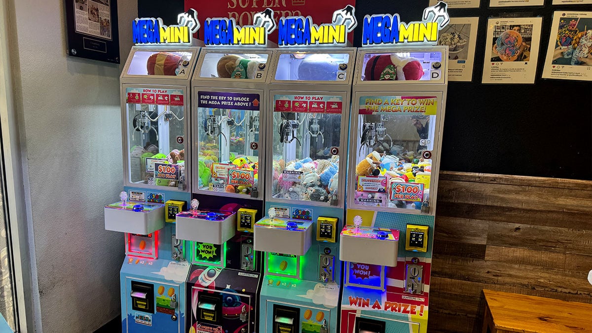mini claw machine filled with plush toys and keychains at creamberry dessert shop in las vegas