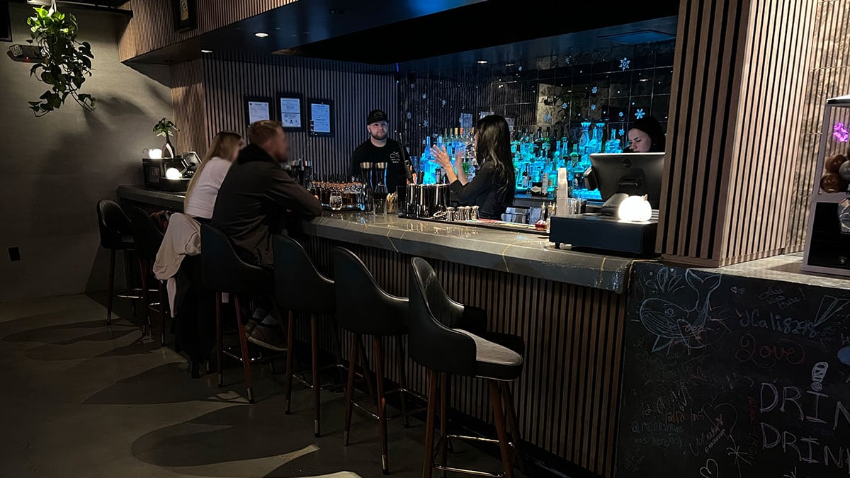 Cozy interior bar vibes inside White Whale with warm lighting and seating.
