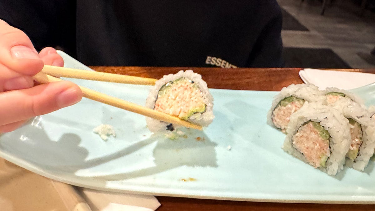 Diners enjoying a fresh California roll sushi at Sushi Fever in Las Vegas.