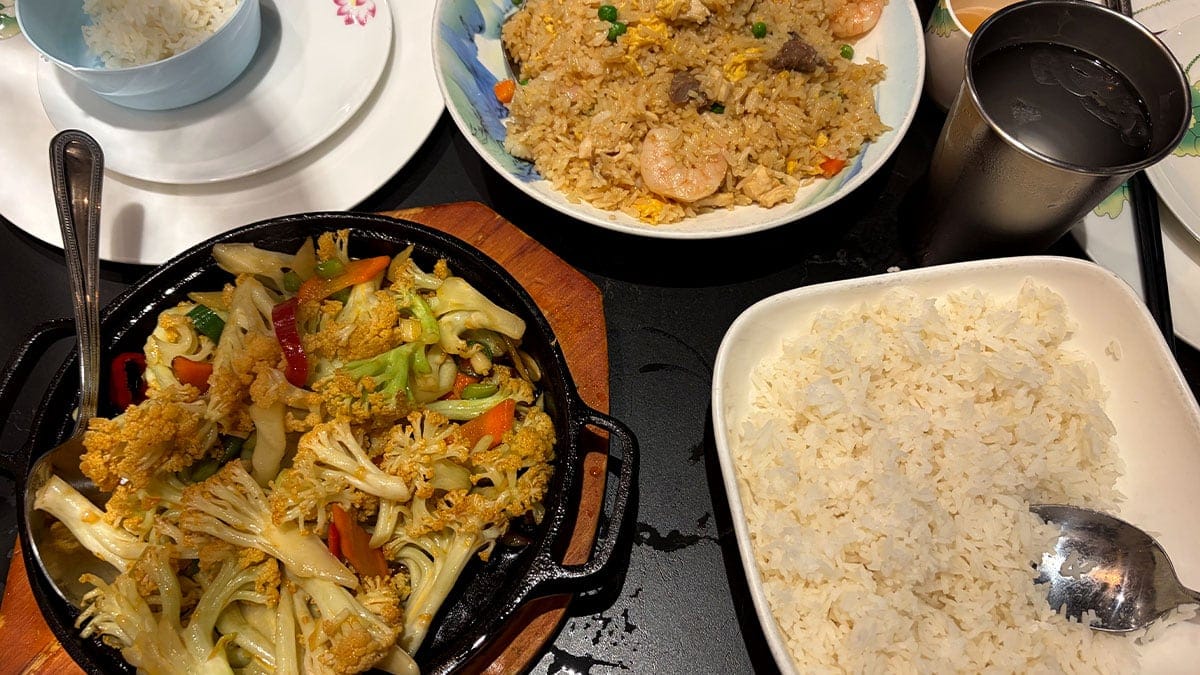 Plate of shrimp fried rice with vegetables served fresh.