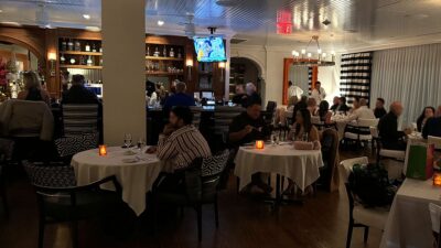 Guests dining and enjoying cocktails inside the bar and dining area at Vintner Grill in Summerlin.