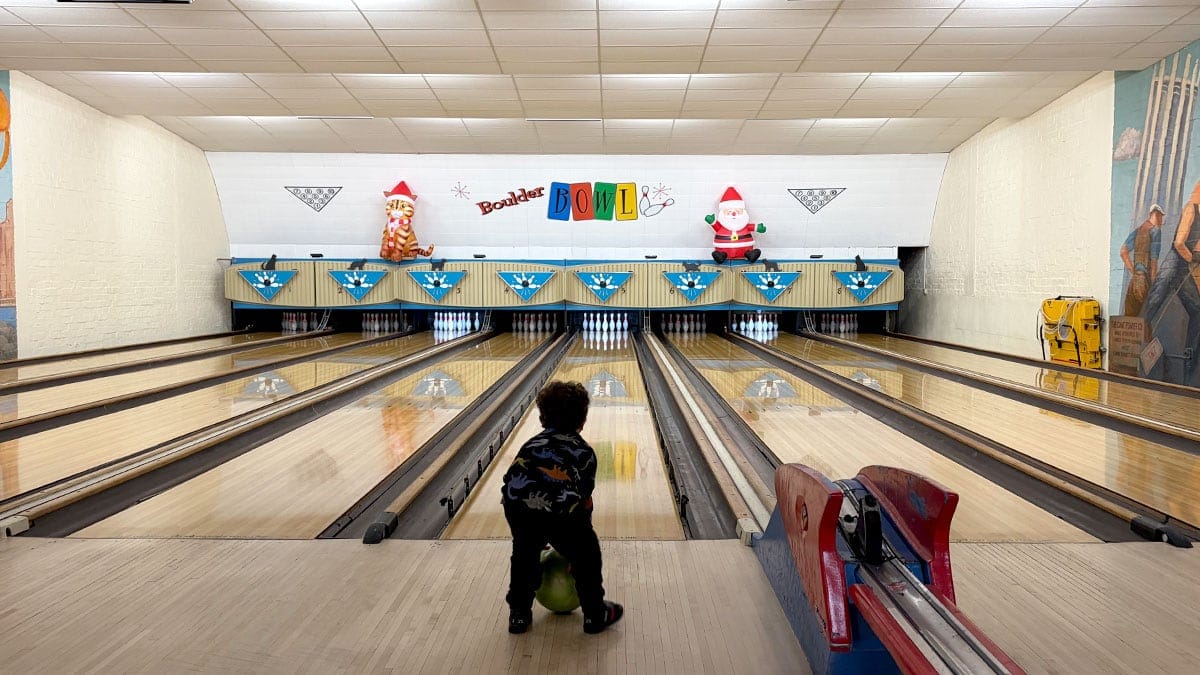 Bowling lanes inside Boulder Bowl with a classic interior and polished lanes.