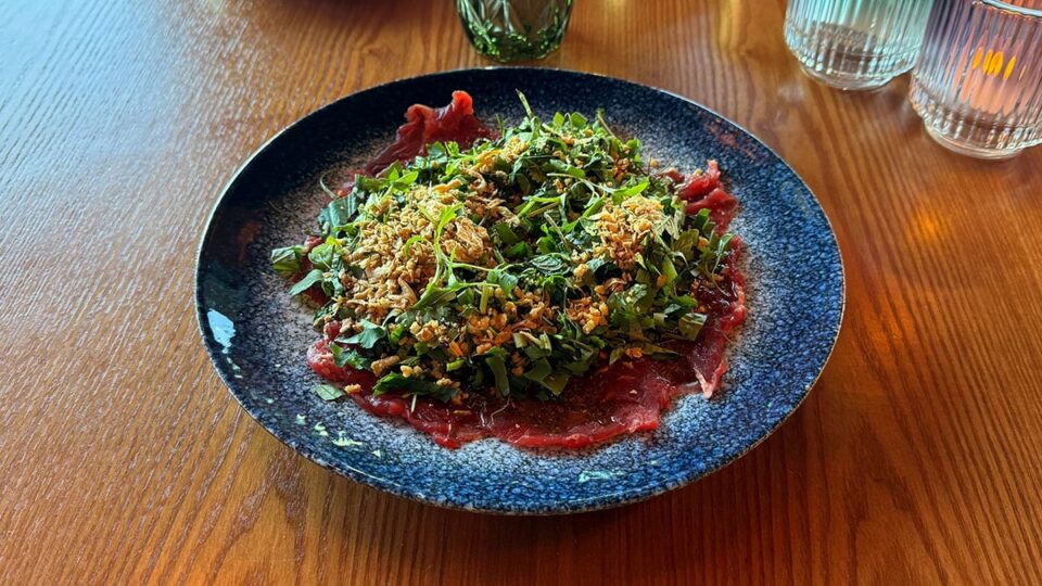 Larb Nuea spicy beef carpaccio with northern Thai spices, lime, cilantro, and crispy shallots