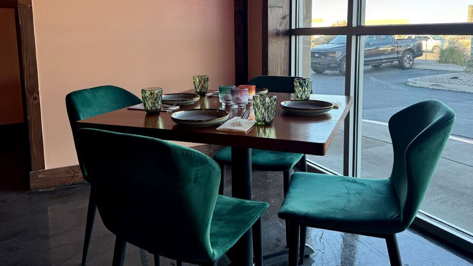 Mid-century modern chairs and table setting inside Amata Modern Thai restaurant