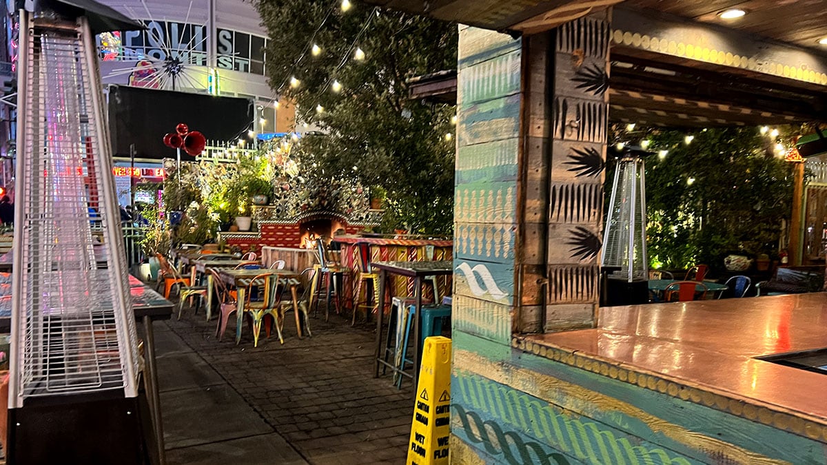 Outside front patio at Park on Fremont in downtown Las Vegas featuring string lights, greenery, and eclectic outdoor seating.