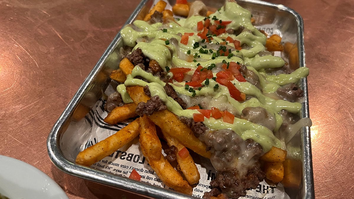 Park Fries at Park on Fremont loaded with ground beef, chipotle sauce, Monterey cheese, grilled onions, tomato, and jalapeño mayo in downtown Las Vegas.