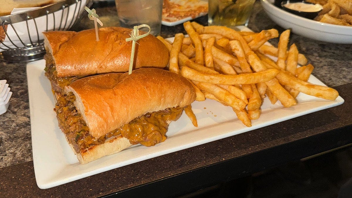 Philly cheesesteak sandwich with shaved beef, grilled onions, peppers, and cheese sauce served at Giuseppe’s Bar & Grille in Southwest Las Vegas.