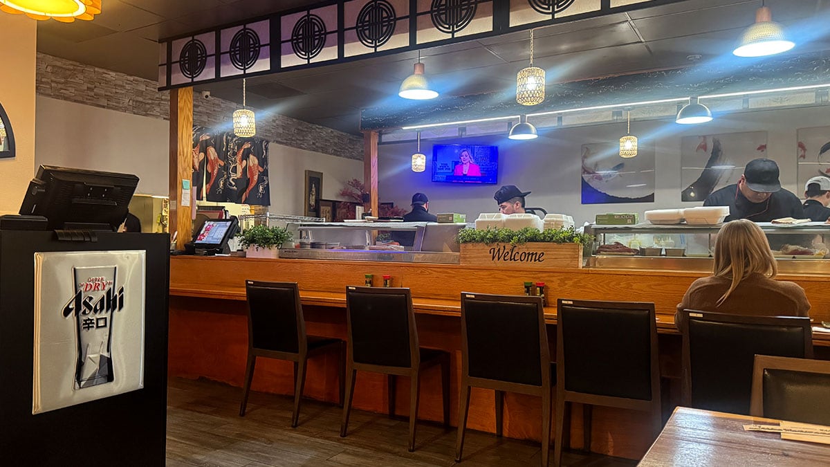 Inside the sushi bar at Sushi Fever in Las Vegas with chefs preparing fresh sushi.