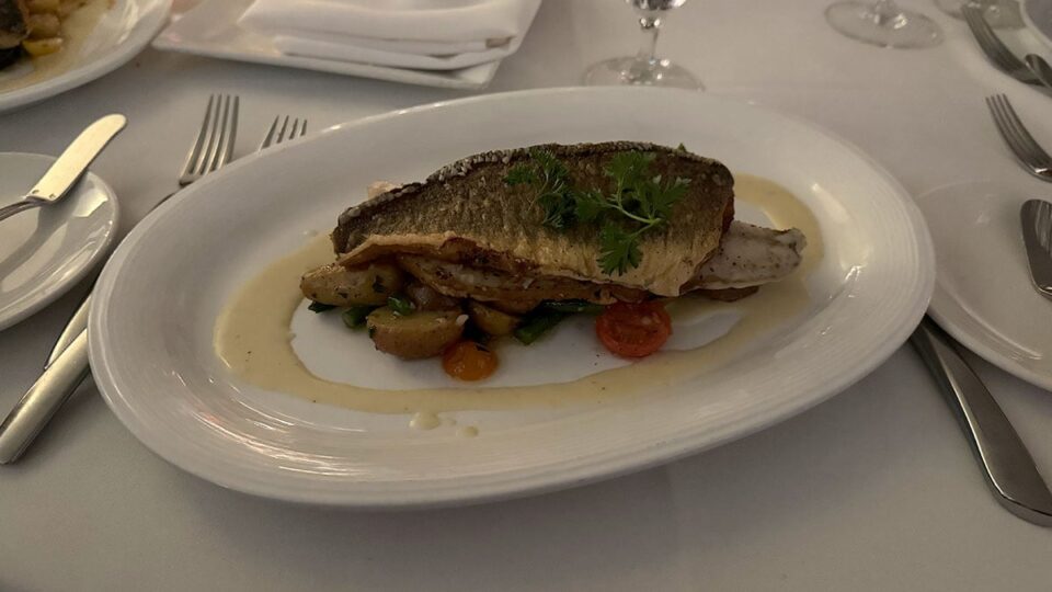 Seared Mediterranean sea bass with marbled baby potatoes, haricots verts, heirloom tomatoes, and Meyer lemon beurre blanc at Vintner Grill.