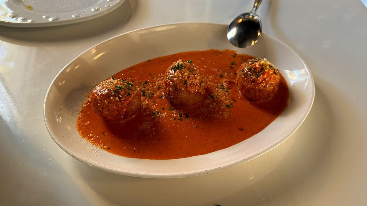 Sicilian arancini with beef, peas, and mozzarella served over Rosa sauce at Brunello Italian restaurant in Sun City Summerlin.