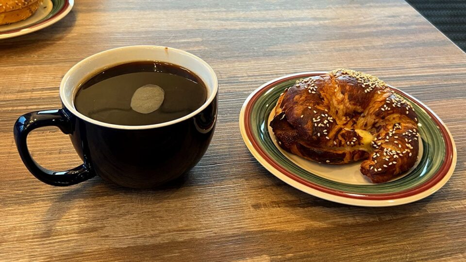 Bacon, eggs, and cheese croissant sandwich served with a large Americano at Exit Zero Coffee in Las Vegas