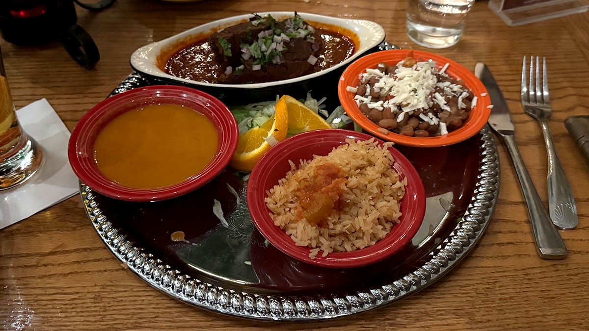 Traditional Birria Chef Ramón featuring tender marinated beef in rich guajillo chile sauce, served with rice, frijoles de la olla, onions, cilantro, lime, and warm tortillas at Pancho’s Mexican Restaurant in Summerlin.