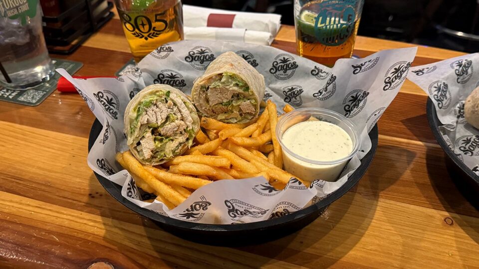 Chicken Caesar wrap served at Sagos Tavern with a side of French fries.