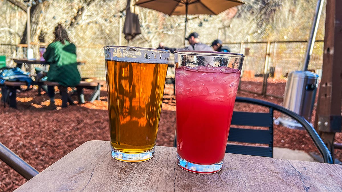 Echo Canyon IPA beer alongside a bright Prickly Pear Lemonade on the patio at Zion Canyon Brew Pub.