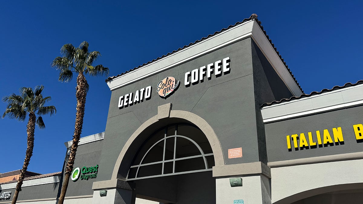 Exterior storefront of Solo Qui café on Lake Mead Boulevard in a neighborhood shopping plaza.