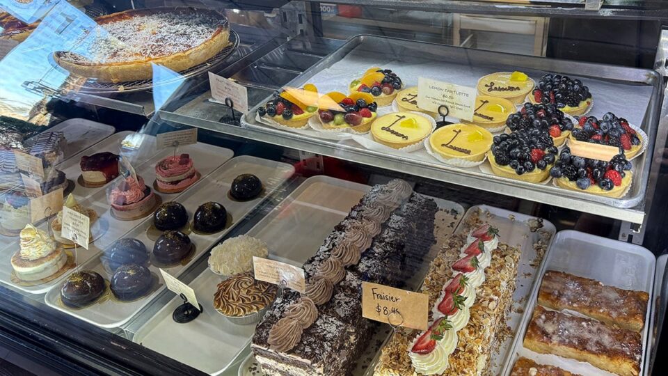 Freshly made French pastries displayed behind the counter at Patisserie Manon