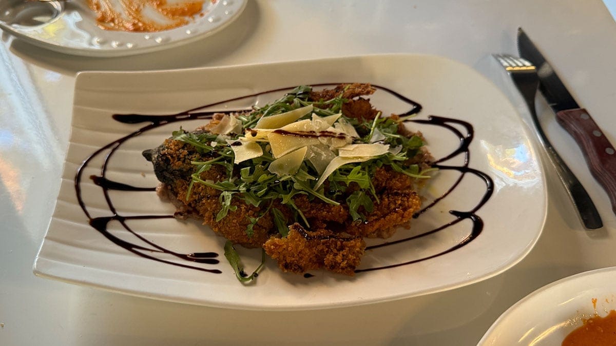 A deep fried whole eggplant, smoked and breaded, served over walnut paste with olive oil and garlic at Brunello Italian restaurant in Sun City Summerlin.