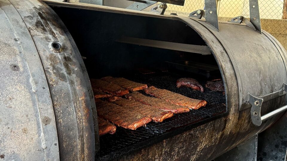St. Louis style ribs smoking on the outdoor pit at Wild Fig BBQ in Summerlin Las Vegas.