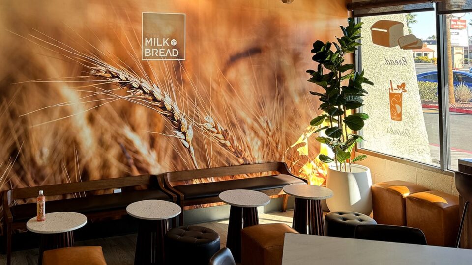 Milk Bread LV decor with wood accents, plants, and natural light.