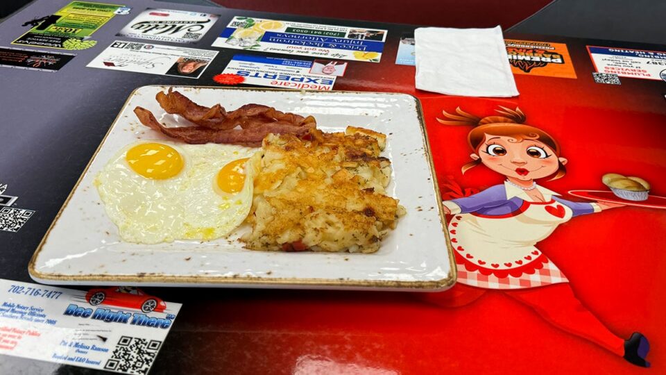 Sunny-side-up eggs with bacon and home fries at Jamms Restaurant